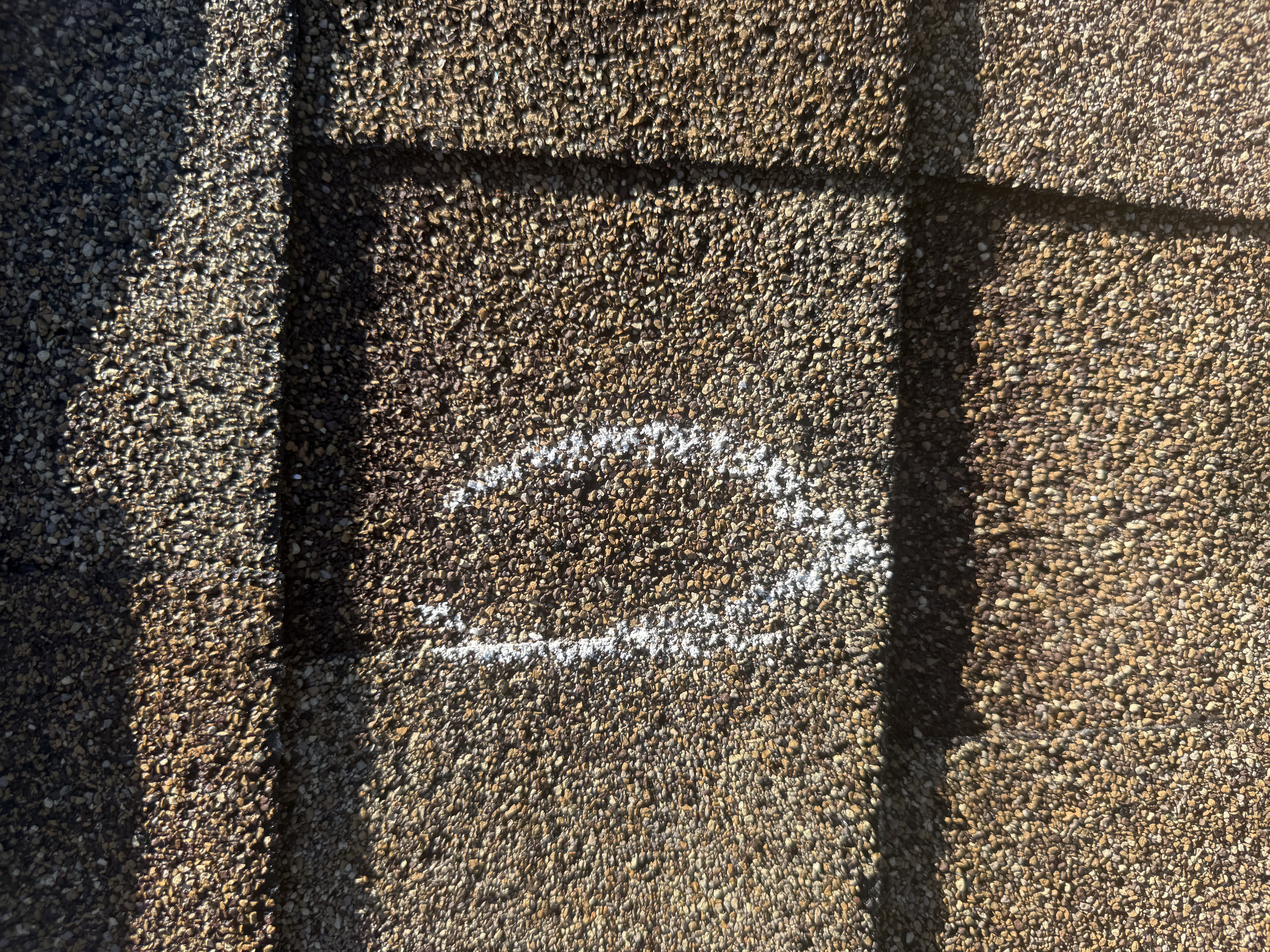 Hail damage showing compromised shingles on a Bloomington property