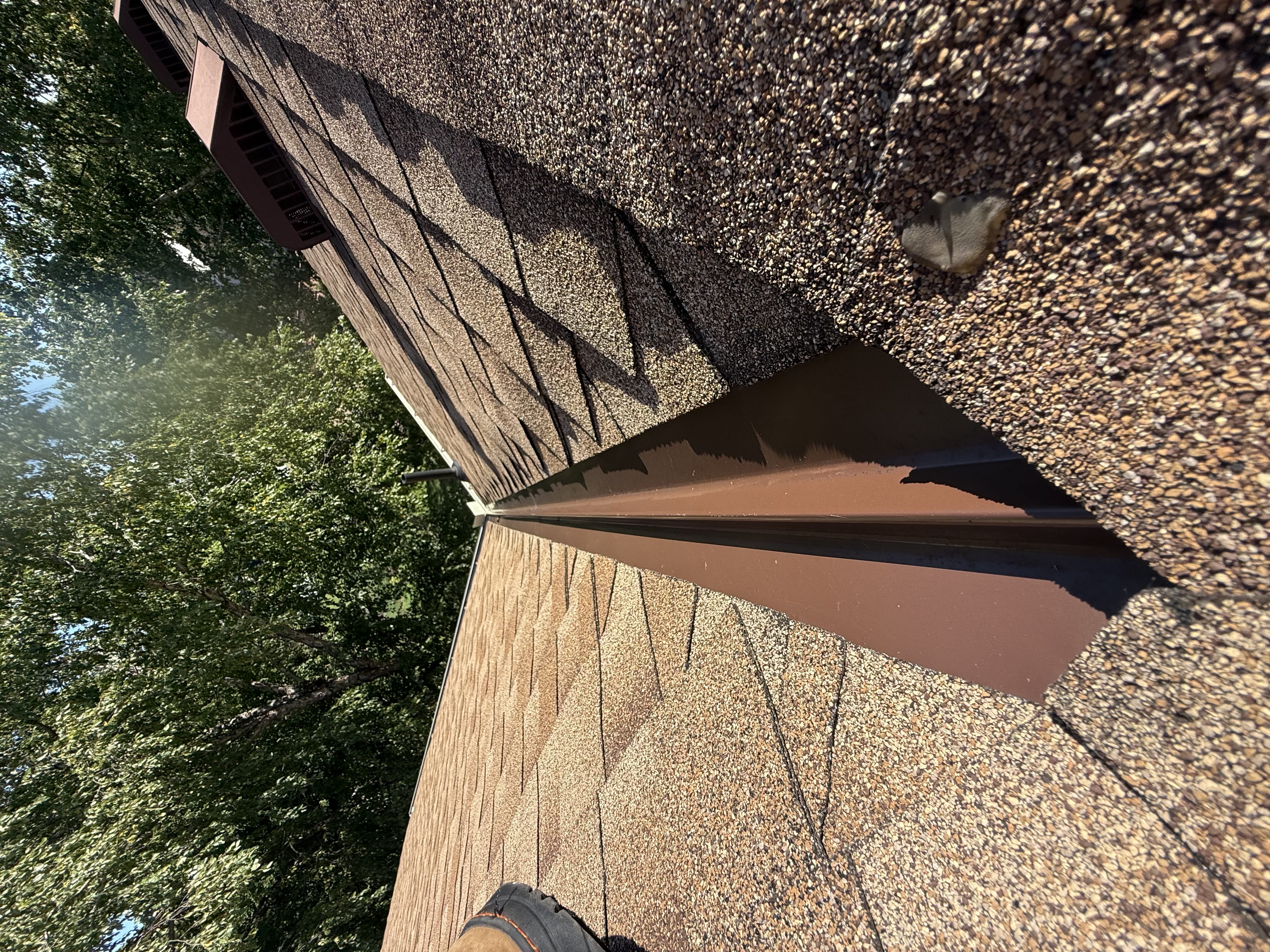 Close inspection of a roof valley and metal flashing line during a drone roof check in Burnsville