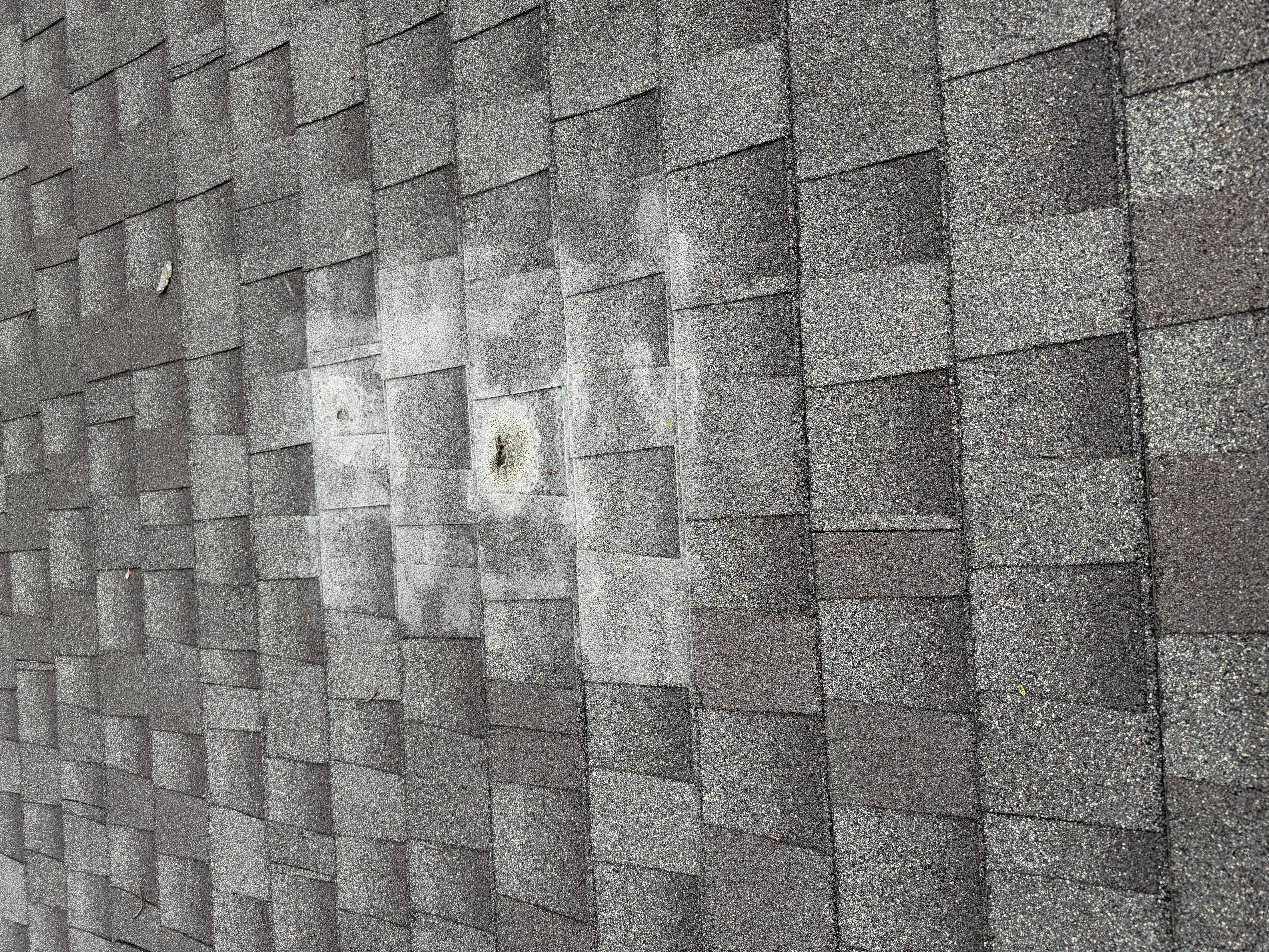 Lakeville Hail Damage Granule Loss Hail damage proof shot showing compromised shingles and commercial membrane in Lakeville
