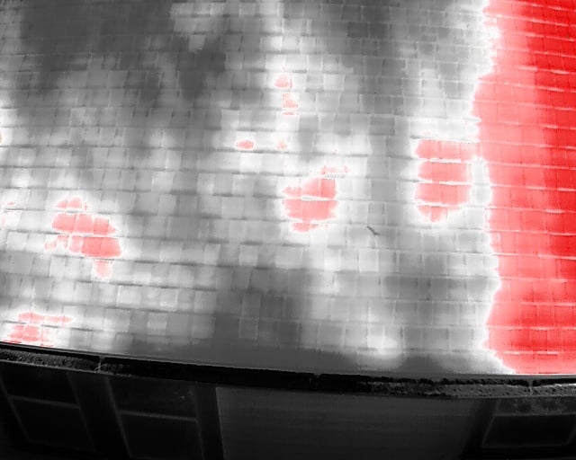 Thermal aerial scan of flat roof showing distinct red hotspots indicating trapped moisture pockets